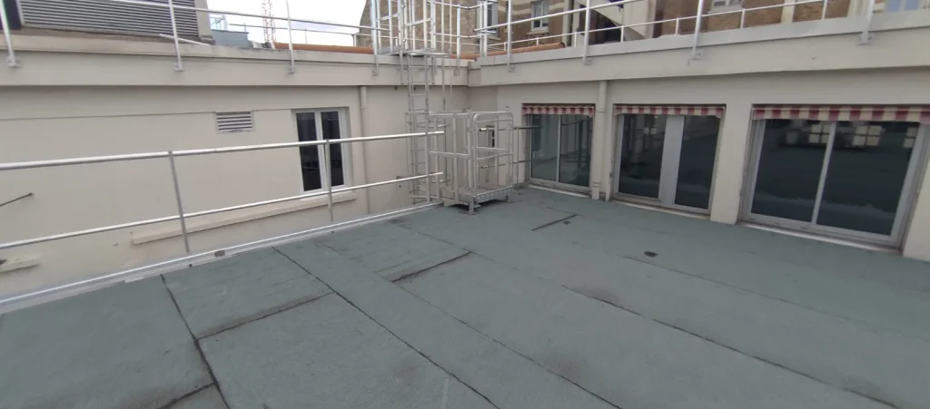 Terrasse technique d'immeuble après réfection de l'étanchéité bitume ardoisée, garde-corps métalliques, étancheur Île-de-France